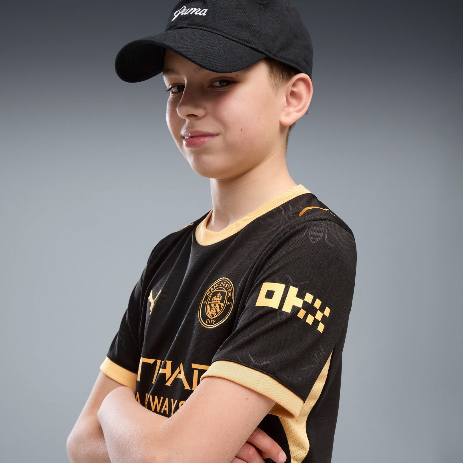 Manchester City Away Jersey Youth in black with gold PUMA and club details.